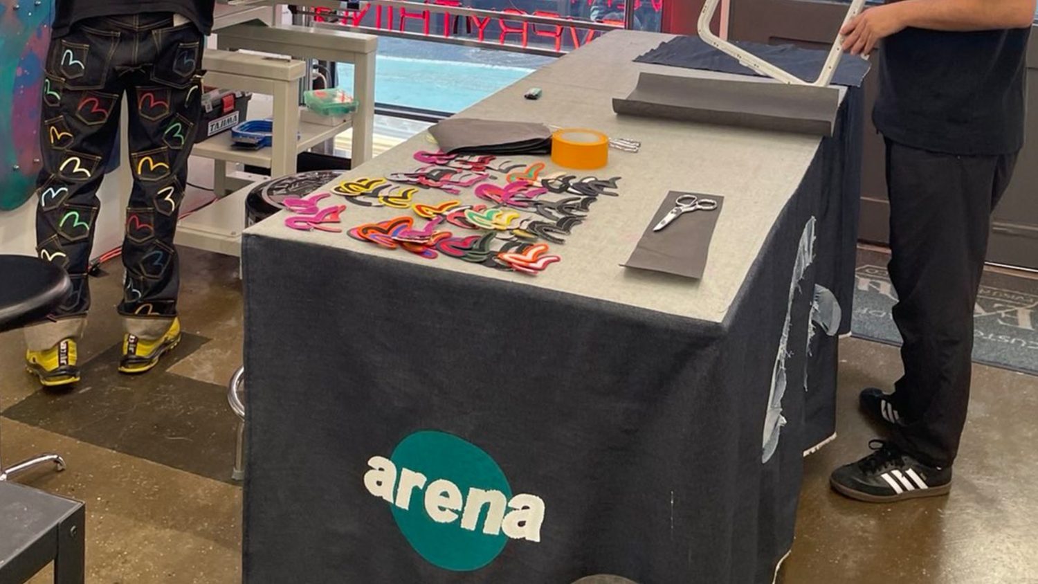Arena Embroidery table at a pop-up, with patches laid out